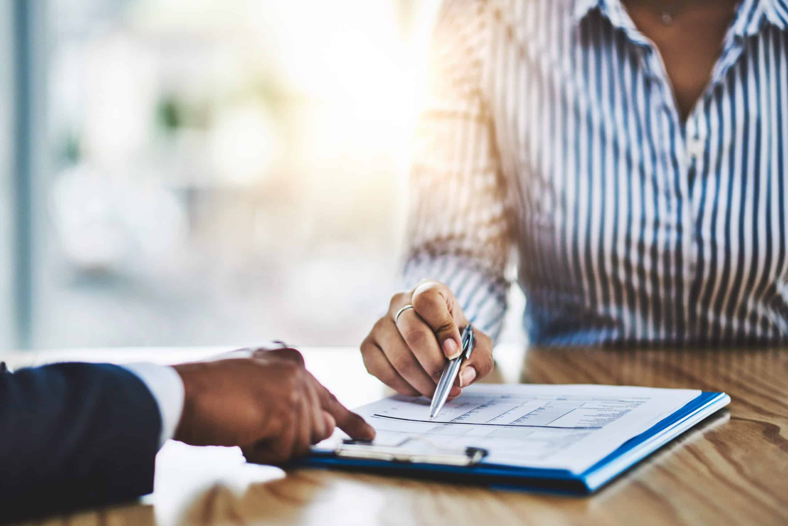 professional reviewing medicolegal report documents during recruitment consultation